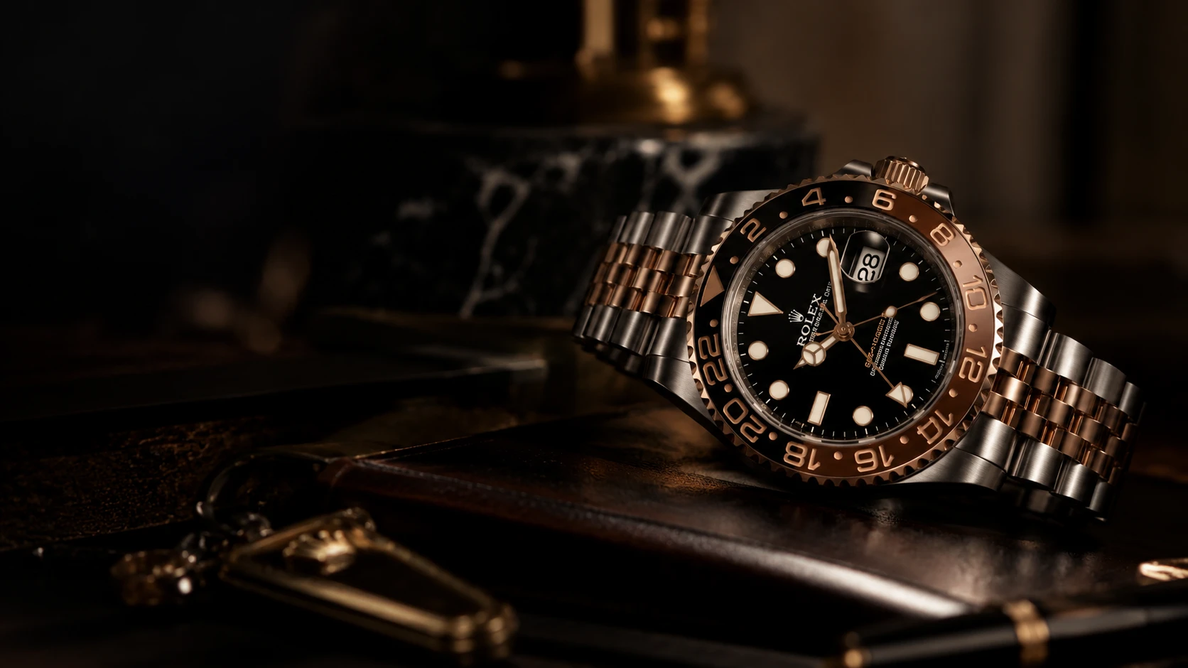 A Rolex GMT-Master II resting on a leather desk